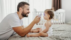 Dad taking a baby's temperature