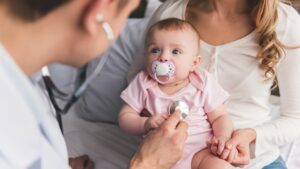 Doctor checking baby's heartbeat